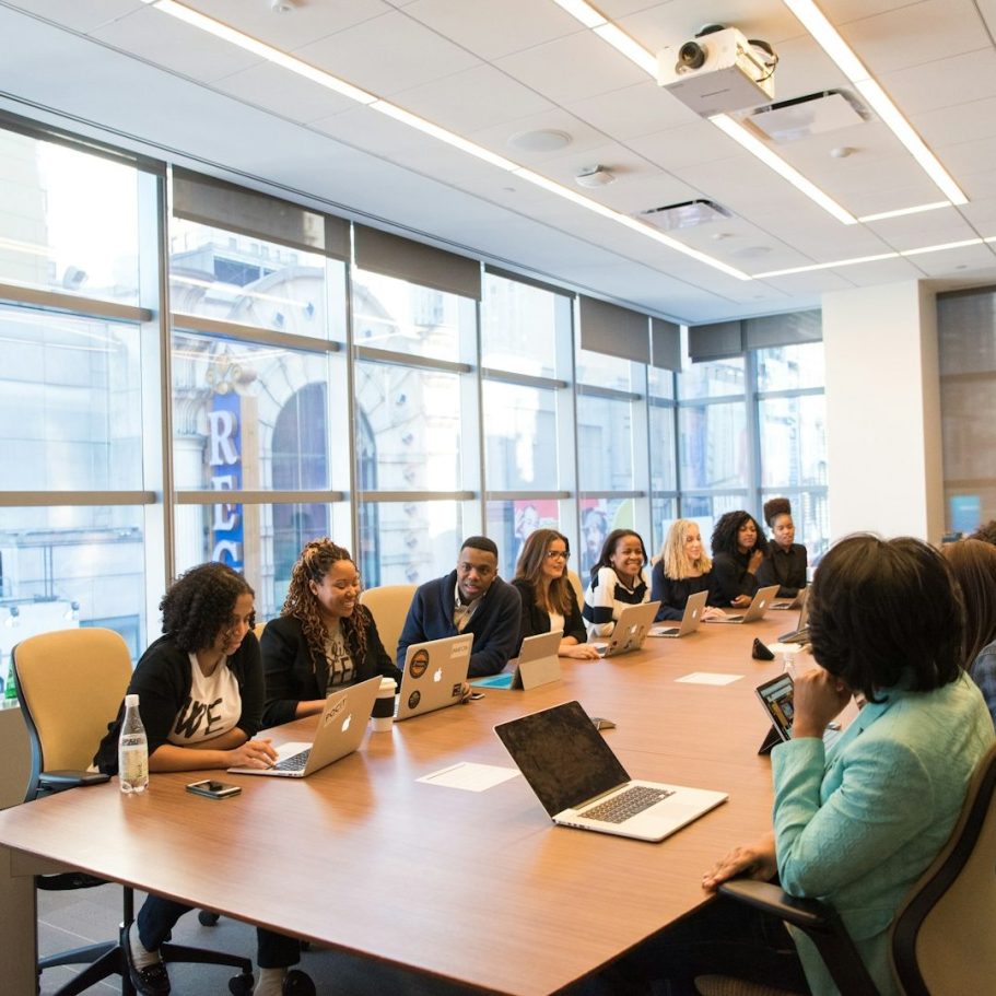 Skill Loop Collective Service Page A diverse group of professionals engaged in a meeting around a conference table.