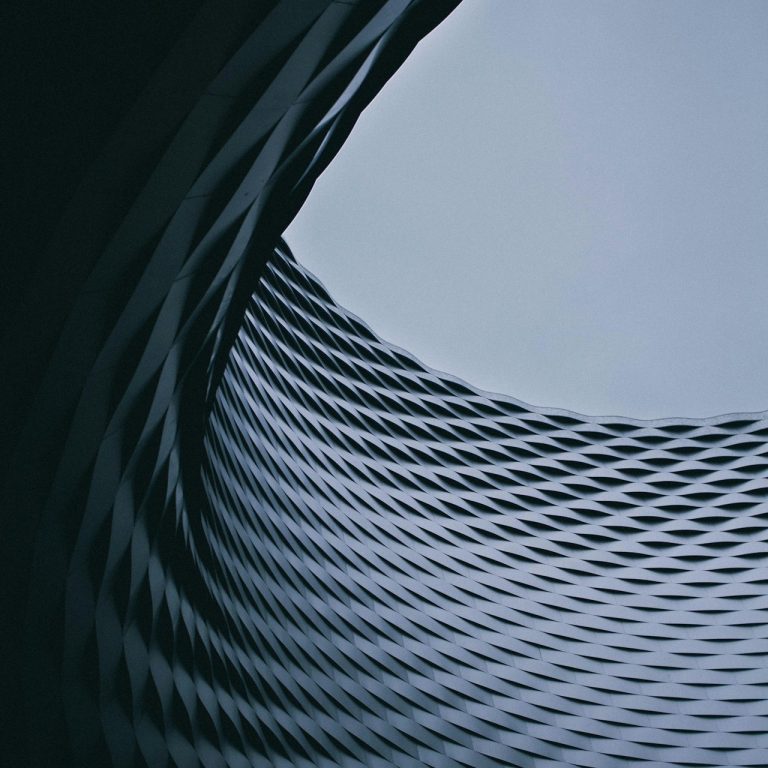 Skill Loop Collective Home Page Abstract geometric patterns forming a spiral with a gradient from dark to light.